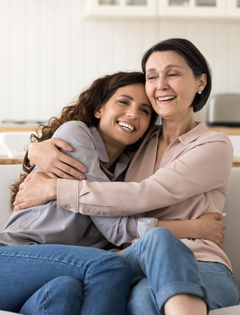 Mother and adult daughter discussing retirement planning together