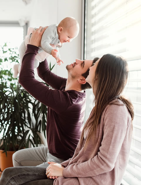 Mother holding her baby while planning for the family's financial future